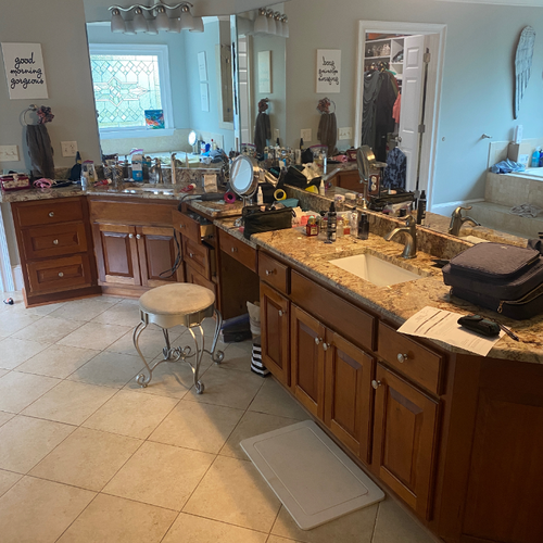Bathroom vanity with outdated wood cabinets