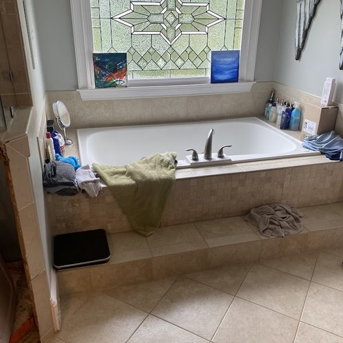 Bathroom with outdated tiles and leaded glass window
