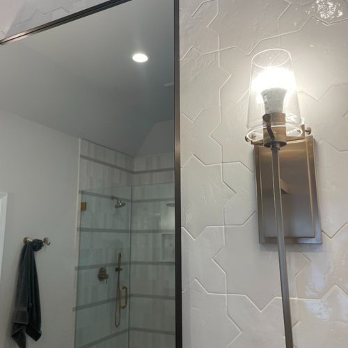 Light fixtures and patterned tile wall installed by Bridgeport Carpets