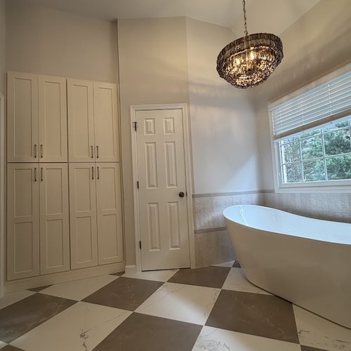 Trendy chandelier over a tub in a newly remodeled Alpharetta, GA bathroom