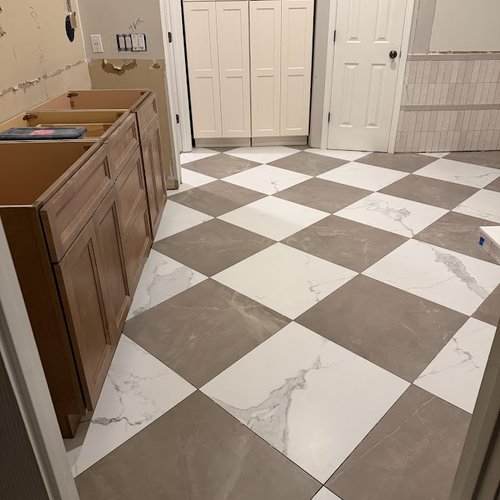 Bathroom flooring project with grey and white checkerboard pattern