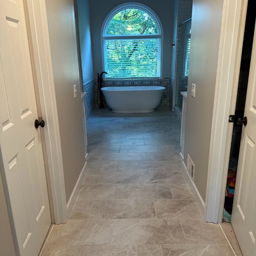 Bathroom hallway with stone tile flooring