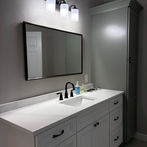 New bathroom cabinets and white marble countertops