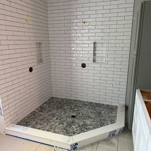 Shower installed by Bridgeport Carpets with white subway tiles