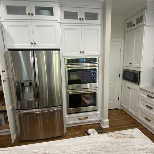 Rustic kitchen counters and white cabinets