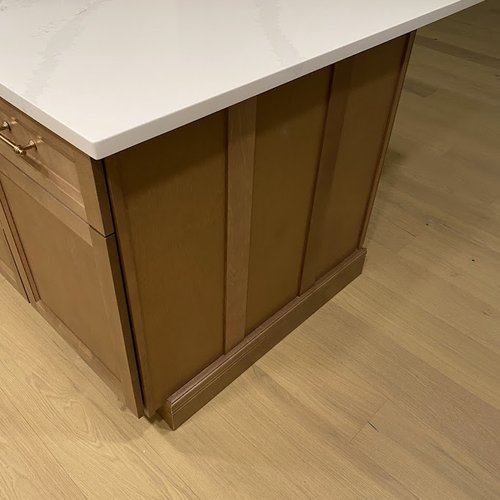 White marble countertops and neutral wood kitchen island