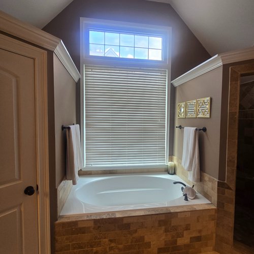 Bathroom with dated stone tile
