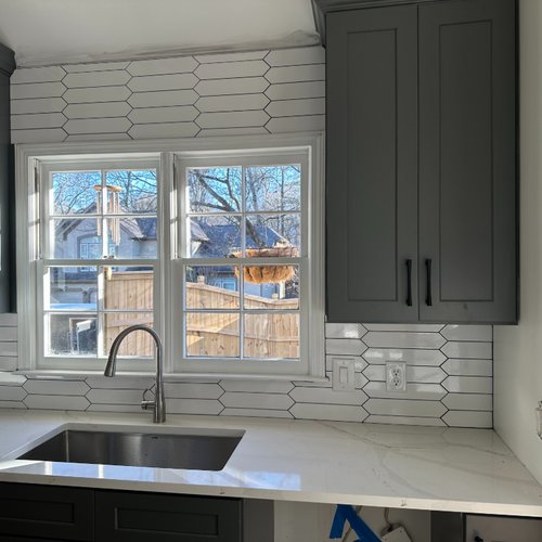 White tile backsplash in a stylish kitchen reno