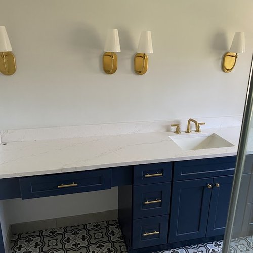 Blue bathroom vanity with white marble countertop