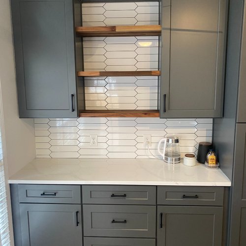 Kitchen cabinets in dark grey with white tile backsplash