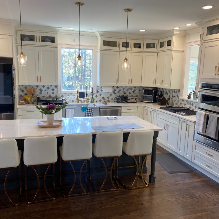 Kitchen with white cabinets and marble countertops