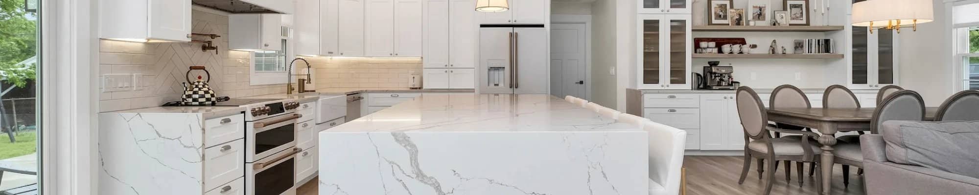 Kitchen with white waterfall marble countertop island