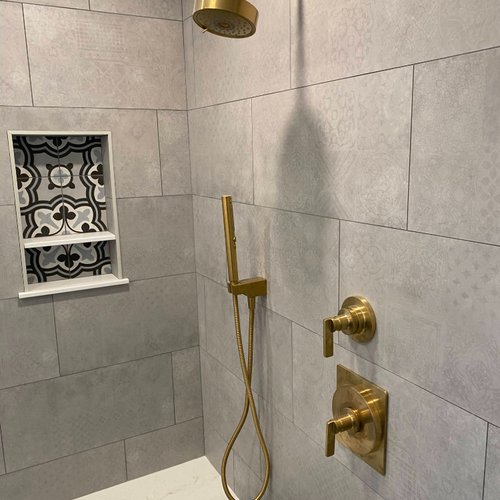 Grey tile shower with gold fixtures in Alpharetta GA