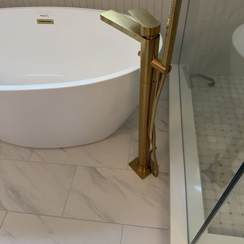 Gold hardware for modern bathtub