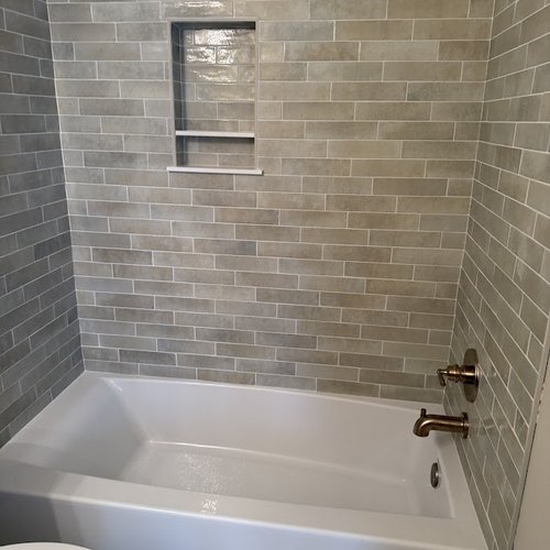 Neutral tile in a shower and tub by Bridgeport Carpets & Flooring