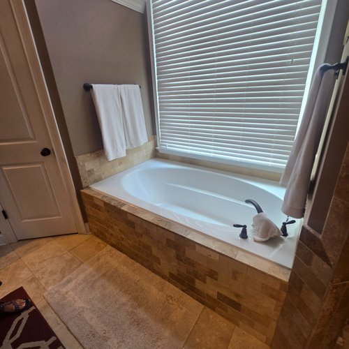Brown tiles in a dated bathroom