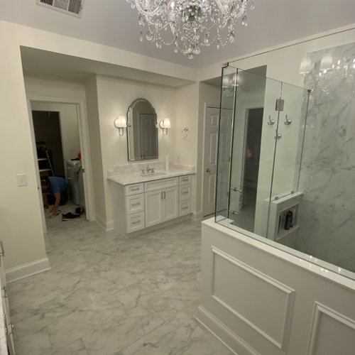 Marble floors and a crystal chandelier in a bathroom