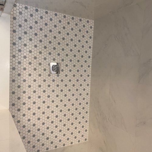 Honeycomb tiles on a shower floor installed by Bridgeport Carpets