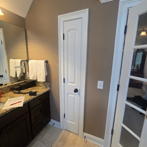 Narrow door in a dated bathroom before remodelling