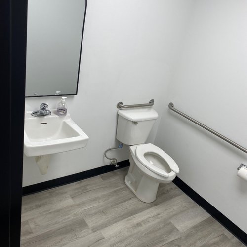 Accessible bathroom with LVP flooring in a commercial building