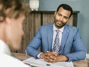 Kitchen with a white waterfall island and sleek white cabinets