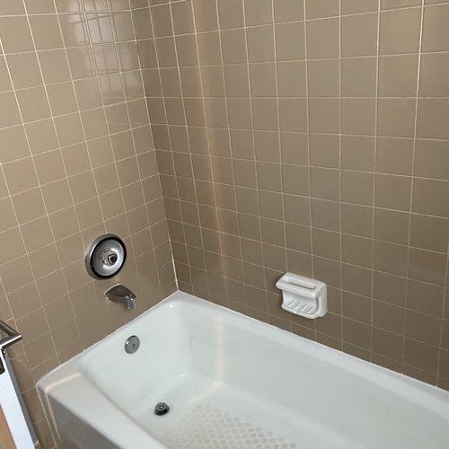 90's style beige tile in a shower