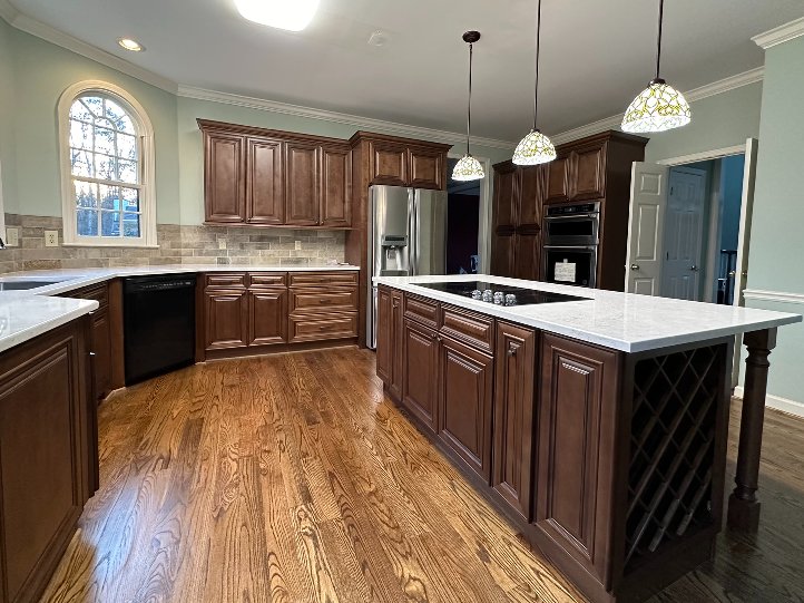 White shaker kitchen remodel wood floor with island