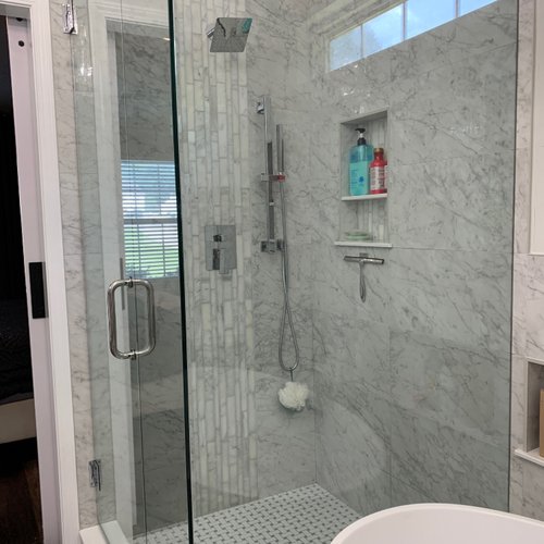 Grey patterened marble tiles in a glass shower
