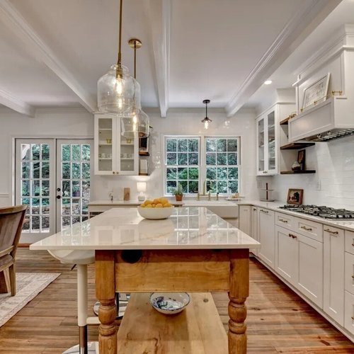 Farmhouse kitchen with marble countertops and gold accents
