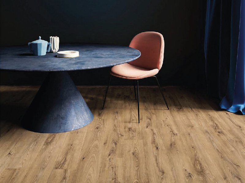 Table and chairs in a dining room with traditional laminate flooring.