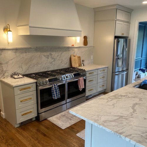 Kitchen with new cabinets and white marble tile