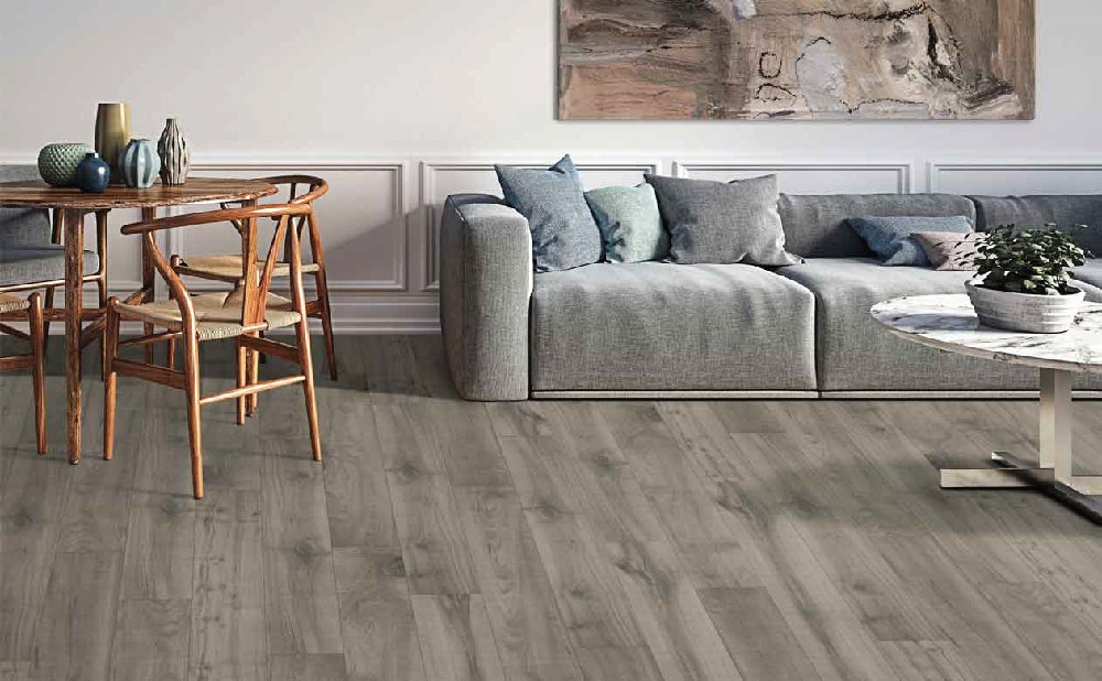 Warm and inviting living room with laminate floors and a couch.